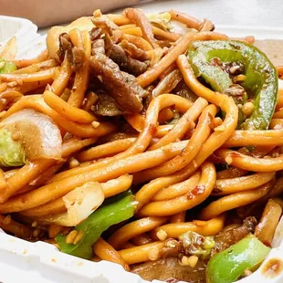 noodles with meat and vegetables in a styrofoam container