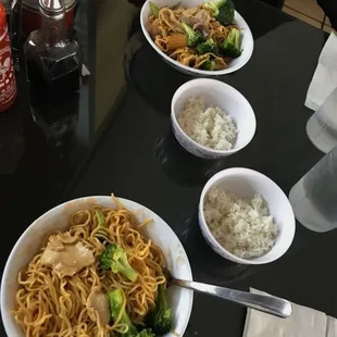 three bowls of noodles and broccoli