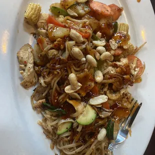 a plate of noodles with meat and vegetables