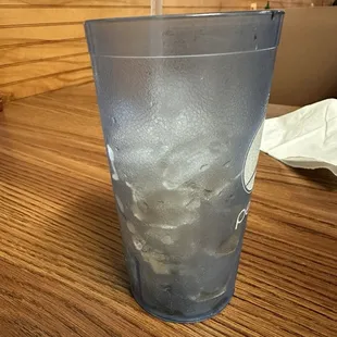 Empty soda cup filled with ice