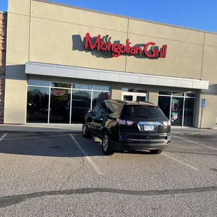 a car parked in front of a restaurant