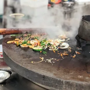 Meat/shrimp and veggies cooking up on the hot grill