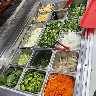a variety of vegetables in trays
