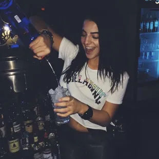 a woman pouring a drink