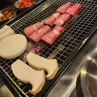 a grill with meat and vegetables