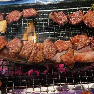 the meat being cooked on the grill