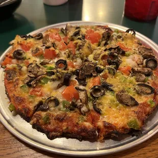 a pizza with mushrooms and tomatoes