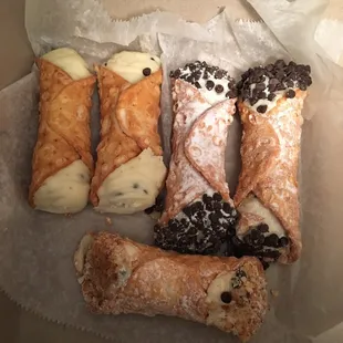 The amazing cannoli!  Three ways, plain, chocolate chip, &amp; nuts! Oops ones missing, started to eat it before I took the picture!