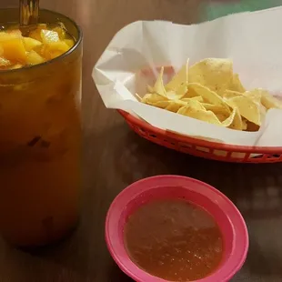 Complimentary chips and salsa with mixed fruit aqua fresca