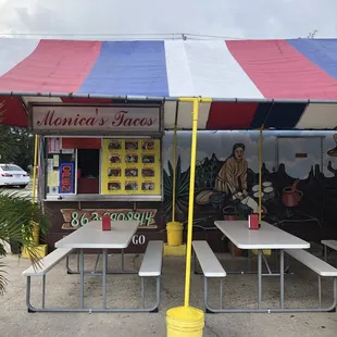 a tent with tables and benches
