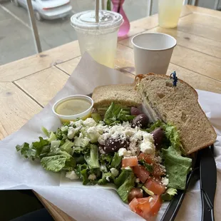 Whole sandwich and Greek salad with lemonade