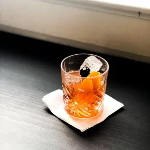 a drink in a glass on a napkin