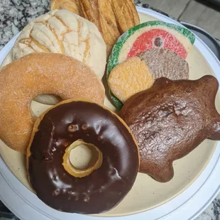 a plate of doughnuts and cookies