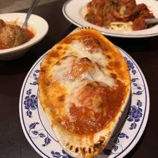 Stuffed shells, meatballs and spaghetti with sauce.