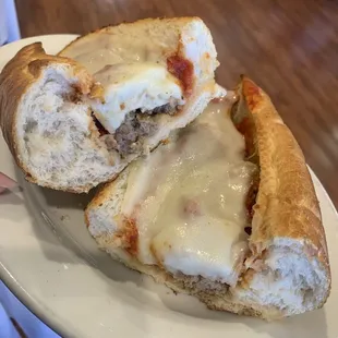 a hand holding a sandwich