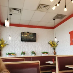 My view of large back area with flower decor and bright lights at each table.  11/1/2024