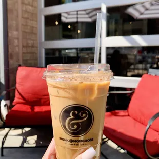 a hand holding a cup of iced coffee