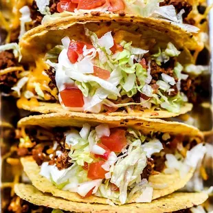 three tacos with toppings