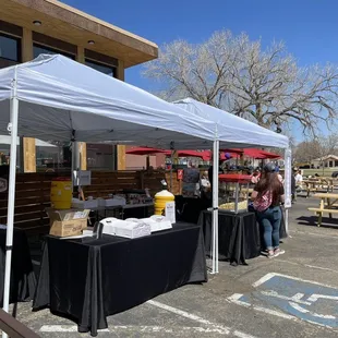a group of people standing under a tent