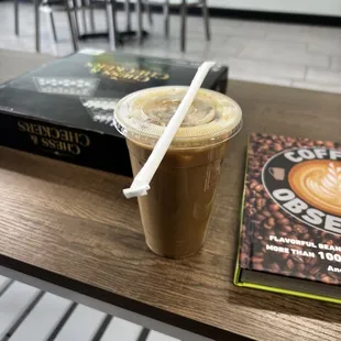 a cup of coffee and a book on a table