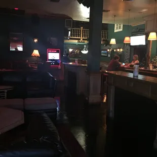Bar area with couches, bar and tables