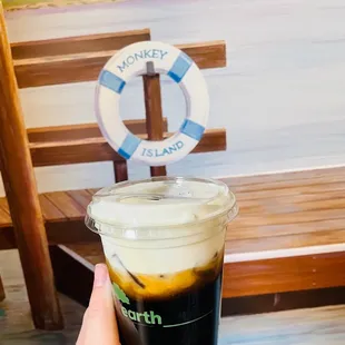 a hand holding a cup of coffee