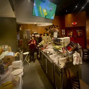 a bar with a tv in the background