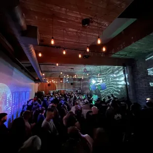 a crowd of people in a dimly lit room