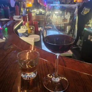 two glasses of wine on a bar