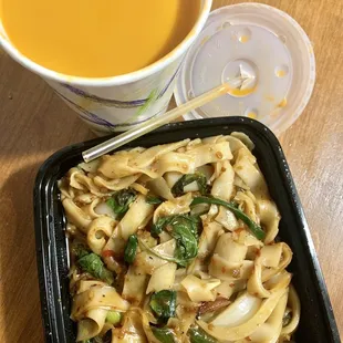 a bowl of noodles and a cup of soup