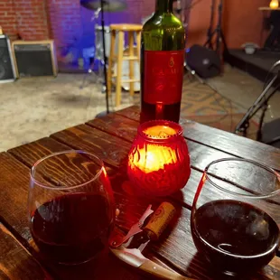 a glass of wine and a candle