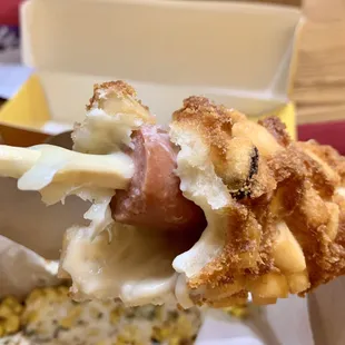 a hand holding a piece of food