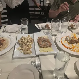 Full table with all appetizers (from left to right: scallops, onion straws, pretzel knots, buffalo cauliflower)