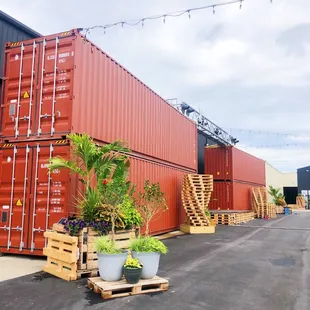 a row of shipping containers in a warehouse yard