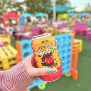 a person holding a can of soda