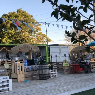 a group of people sitting at tables outside