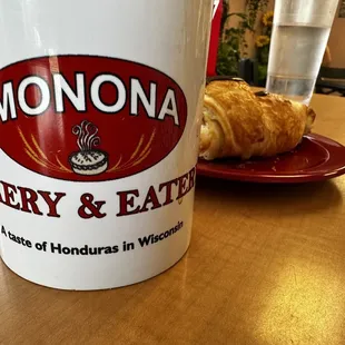 a cup of coffee and a croissant