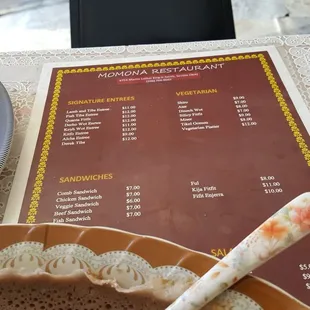 a menu and a plate of bread