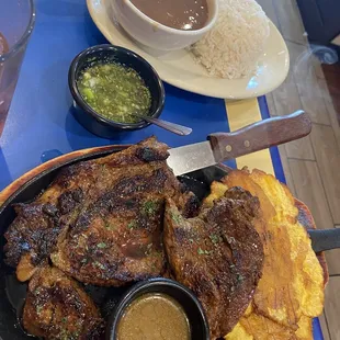 Churrasco served w/ plaintains and side of rice and beans.