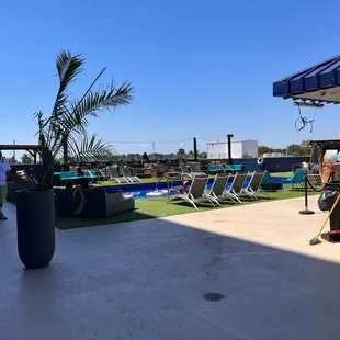 a man cleaning a patio with a mop