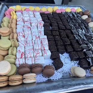 a tray of assorted cookies and pastries