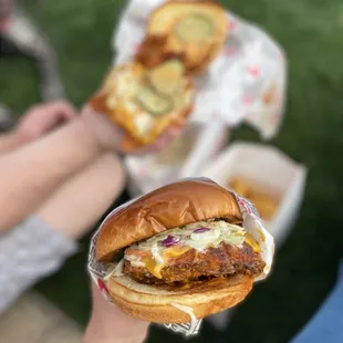 a person holding a sandwich