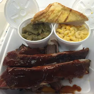 Two meat lunch combo. Ribs and beef brisket. Side of green beans (INCREDIBLE) and Mac n cheese and good old Texas toast.