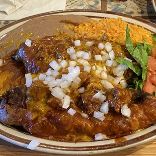 Double stuffed chile relleno plate. One stuffed with carne adovada and the other stuffed with ground beef smothered in red chile!