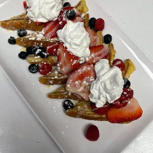 a plate of fruit and cream