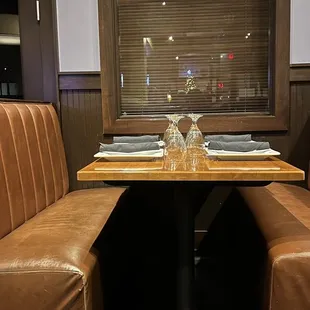 a corner booth with leather seating