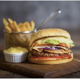 a burger and fries on a cutting board