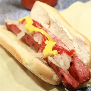 a hot dog with mustard and onions