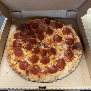 a pepperoni pizza in a box