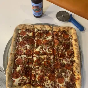 pepperoni, sausage, and cheese on a pizza pan